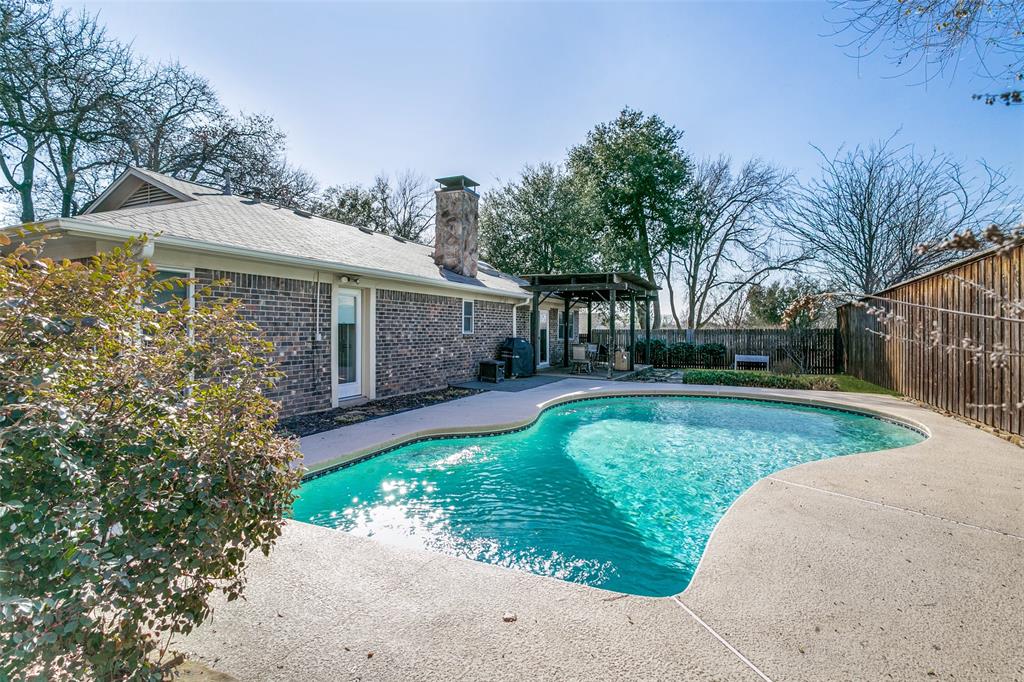 2922 Ridgewood Drive Grapevine, TX 76051 - Photo 24 of 25 a view of a white house with a small yard and potted plants