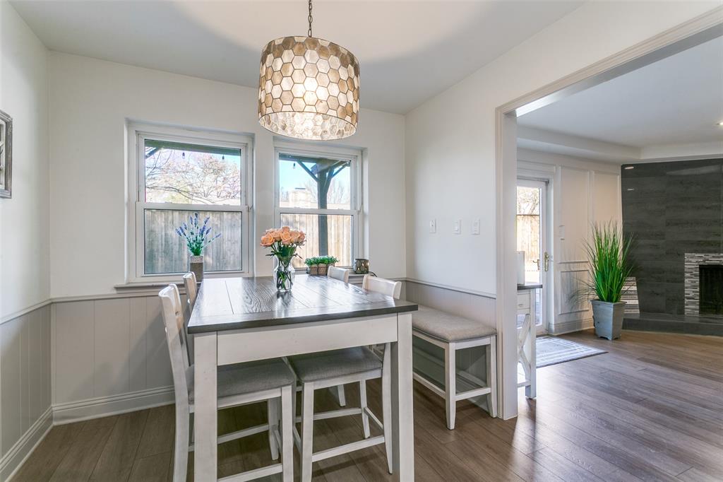 2922 Ridgewood Drive Grapevine, TX 76051 - Photo 10 of 25 a dining room with wooden floor a chandelier a wooden table and chairs
