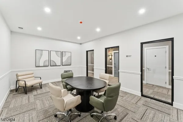 a large white room with large windows and furniture