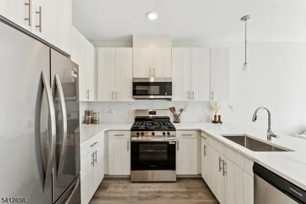 a kitchen with a sink stove and refrigerator