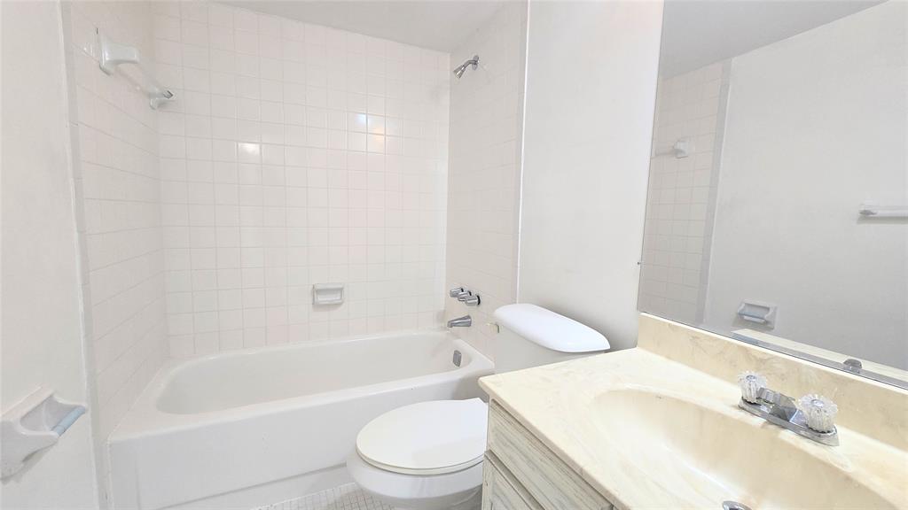 8401 West Sample Road, Unit 48 Coral Springs, FL 33065 - Photo 13 of 26 a bathroom with a bathtub shower sink vanity and toilet