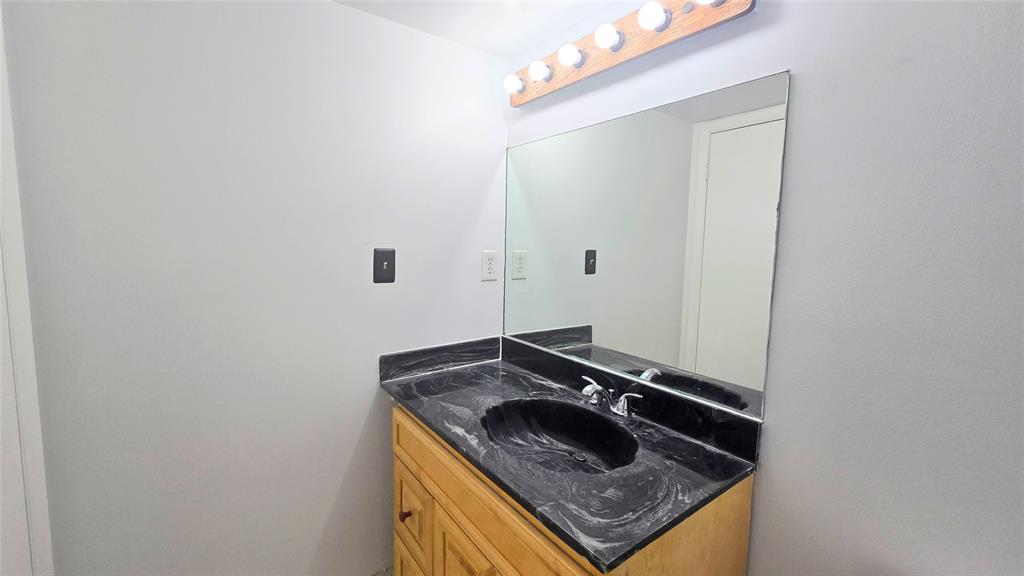 8401 West Sample Road, Unit 48 Coral Springs, FL 33065 - Photo 5 of 26 a bathroom with a granite countertop sink and a mirror
