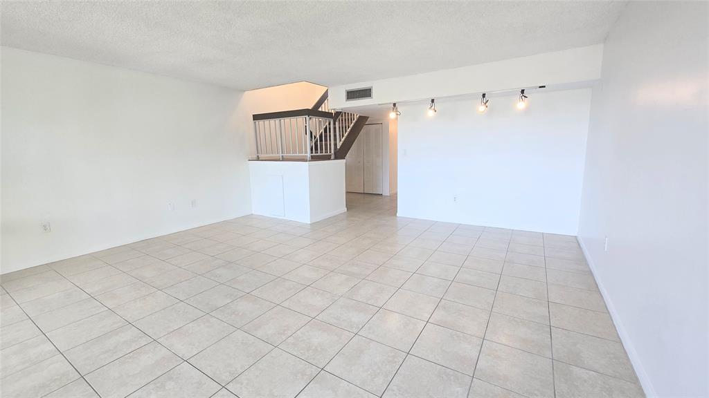 8401 West Sample Road, Unit 48 Coral Springs, FL 33065 - Photo 8 of 26 a view of a hallway with stairs