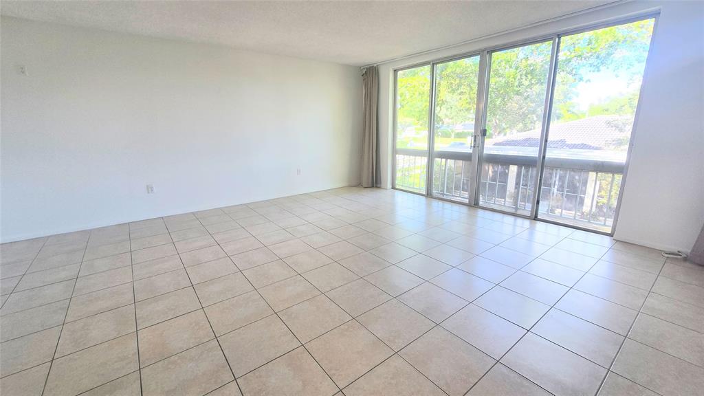 8401 West Sample Road, Unit 48 Coral Springs, FL 33065 - Photo 9 of 26 a view of an empty room and window