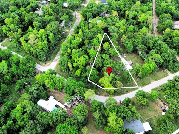 an aerial view of residential house with an outdoor space and trees