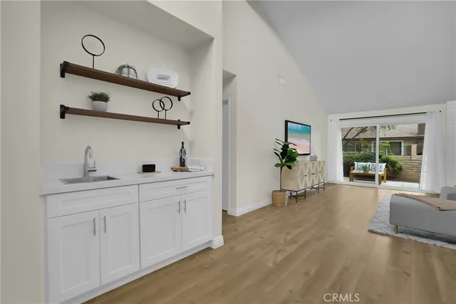 a dining room with furniture a chandelier and wooden floor