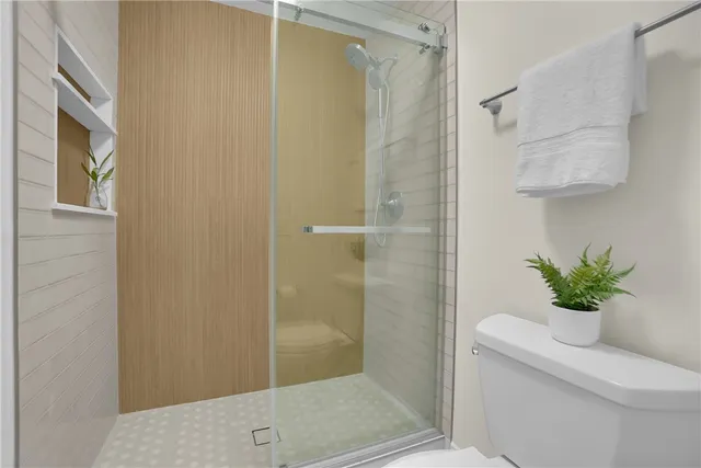 a bedroom with a bed and painting on the wall