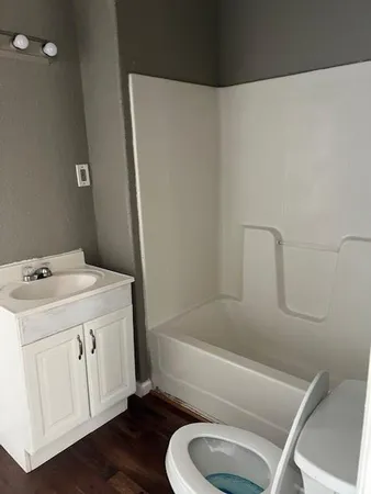 a bathroom with a sink a toilet and bathtub