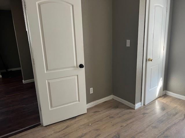 714 North Commerce Street Gainesville, TX 76240 - Photo 18 of 19 an empty room with wooden floor and closet