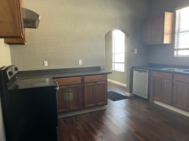 714 North Commerce Street Gainesville, TX 76240 - Photo 9 of 19 a kitchen with a sink a window and wooden floor