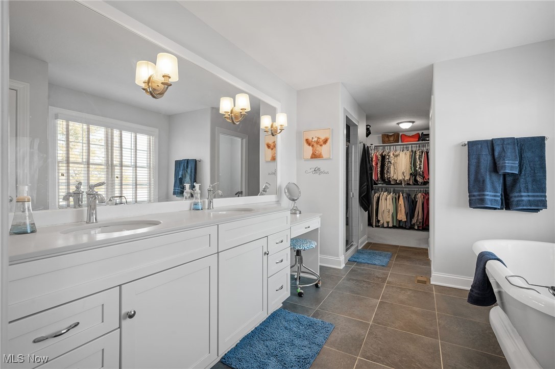 3777 Hunting Run Road Medina, OH 44256 - Photo 28 of 46 Bathroom featuring vanity, a bathing tub, and tile patterned floors