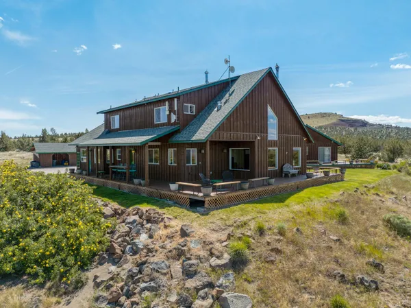 a view of a house with swimming pool and porch