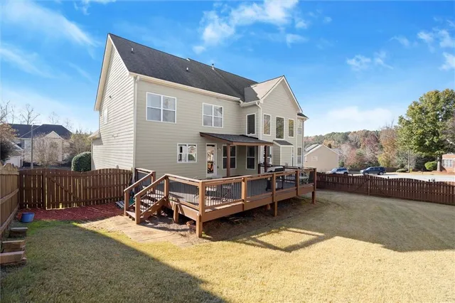a view of house with yard and sitting area