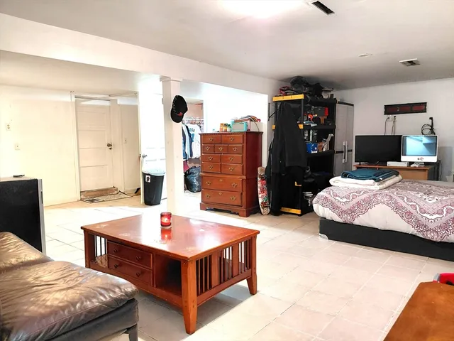 a bedroom with a bed and a flat tv screen