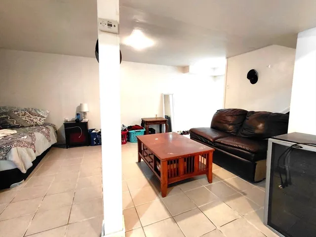 a living room with furniture and a lamp