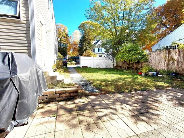 a view of yard in front of house with trees