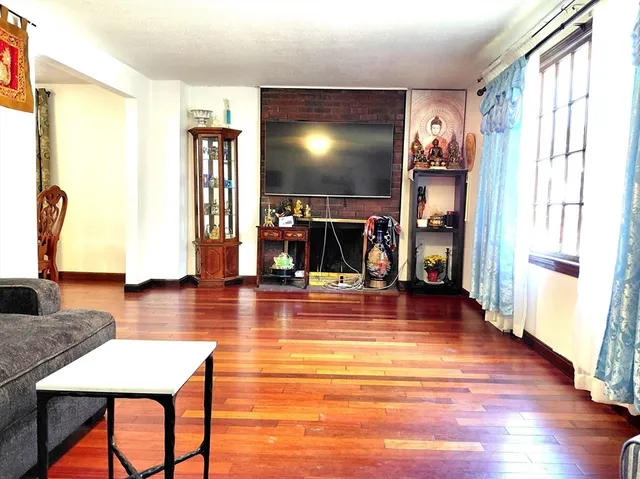 a view of a livingroom with furniture window and wooden floor