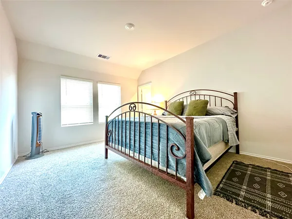 a bedroom with furniture and a window