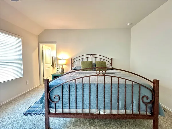 a view of a bedroom with wooden floor