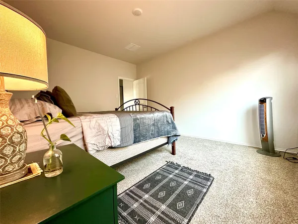 a bedroom with a bed and a night stand