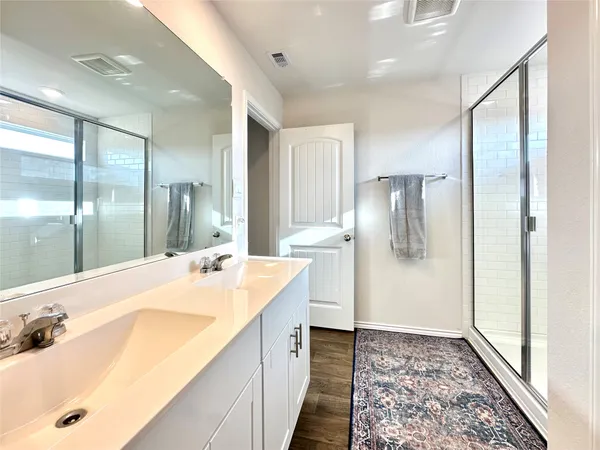 a bathroom with a tub sink and mirror