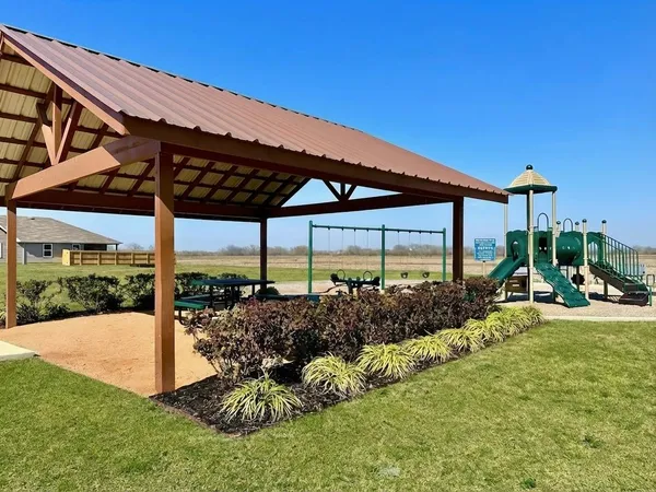 a view of a patio with table and chairs under an umbrella