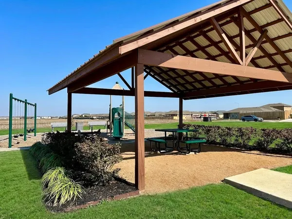 a view of a patio with a table chairs and a backyard