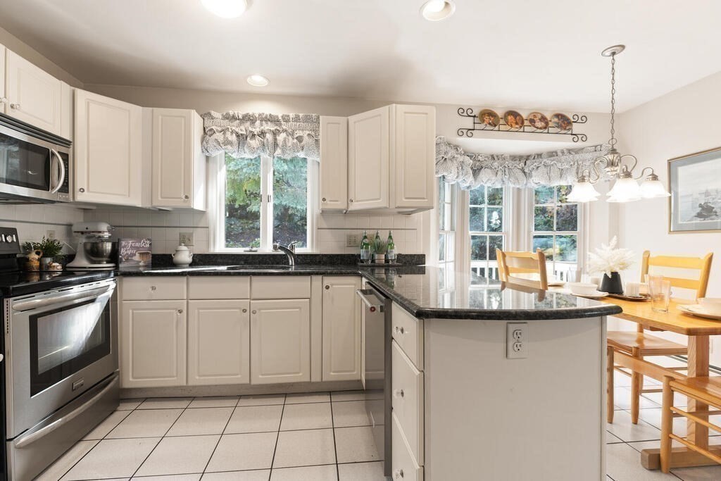 6 Wickham Road Winchester, MA 01890 - Photo 12 of 37 a kitchen with stainless steel appliances granite countertop a sink and a stove