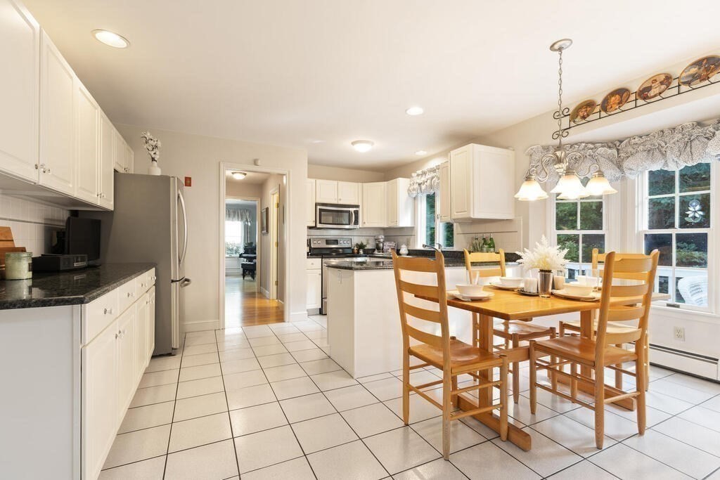 6 Wickham Road Winchester, MA 01890 - Photo 13 of 37 a kitchen with stainless steel appliances kitchen island granite countertop a refrigerator and cabinets