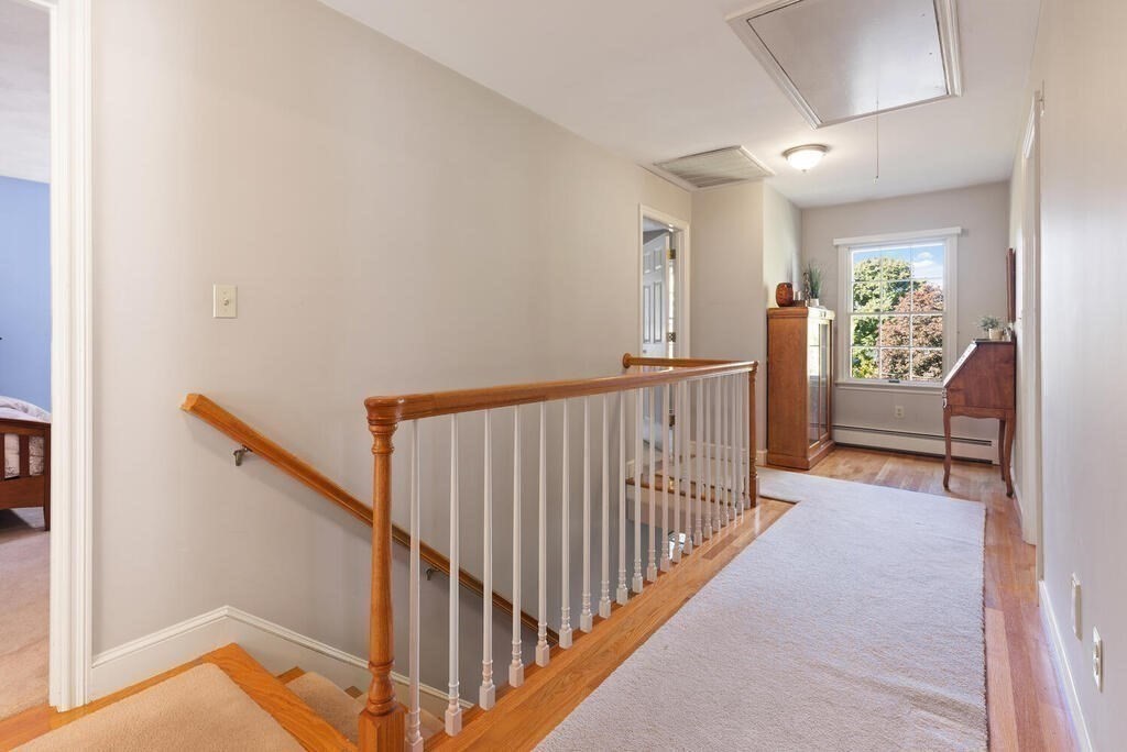 6 Wickham Road Winchester, MA 01890 - Photo 19 of 37 a view of a hallway with wooden floor and stairs