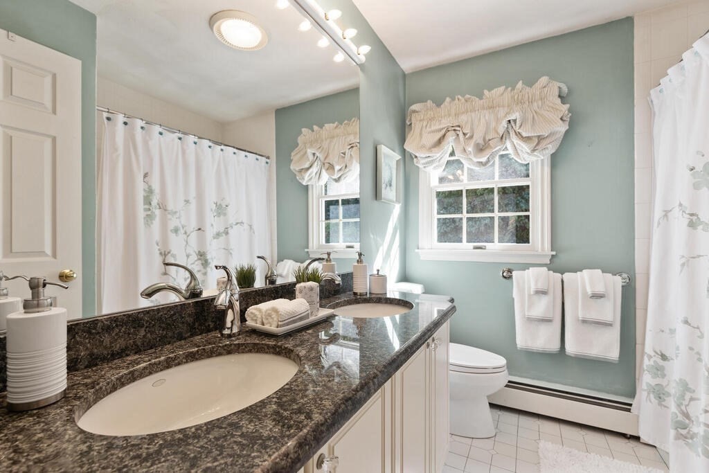 6 Wickham Road Winchester, MA 01890 - Photo 26 of 37 a bathroom with a granite countertop sink and a mirror