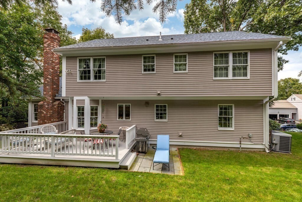 6 Wickham Road Winchester, MA 01890 - Photo 29 of 37 a front view of a house with a yard table and chairs
