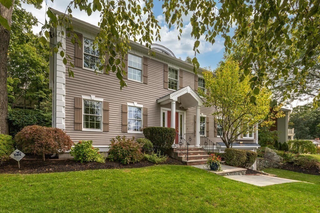 6 Wickham Road Winchester, MA 01890 - Photo 5 of 37 a front view of a house with a yard and garage