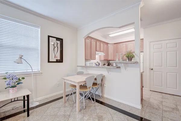a kitchen with a table and chairs