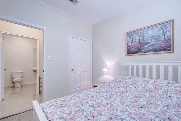 a bedroom with a bed and a painting on the wall
