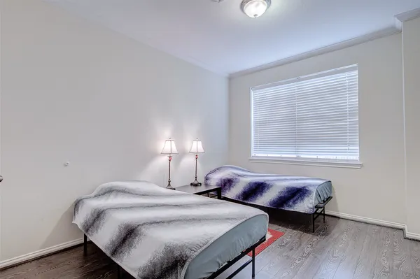 a bedroom with bed and a window