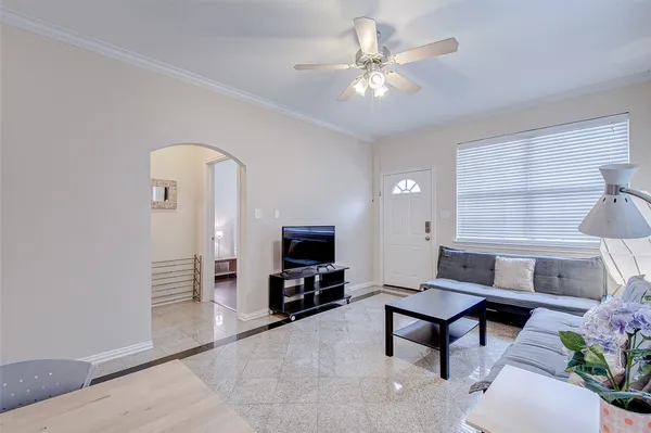 a living room with furniture and a chandelier