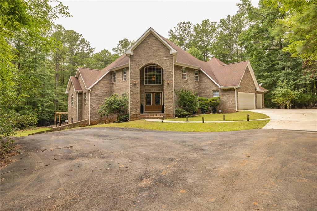394 South Alexander Creek Road Newnan, GA 30263 - Photo 11 of 76 a view of a house with a yard and large tree