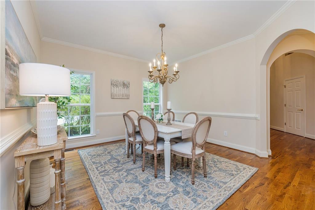 394 South Alexander Creek Road Newnan, GA 30263 - Photo 17 of 76 a dining room with furniture a rug and wooden floor