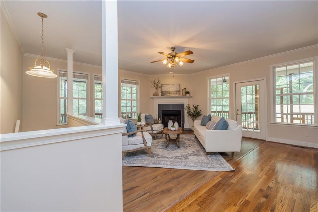 394 South Alexander Creek Road Newnan, GA 30263 - Photo 18 of 76 a living room with furniture a fireplace and a large window