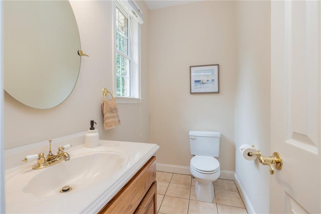 394 South Alexander Creek Road Newnan, GA 30263 - Photo 25 of 76 a bathroom with a toilet a sink and mirror