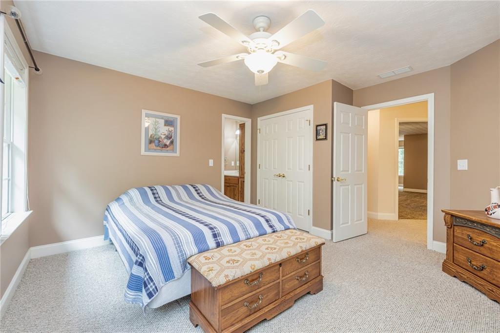 394 South Alexander Creek Road Newnan, GA 30263 - Photo 37 of 76 a bedroom with a bed and a chandelier