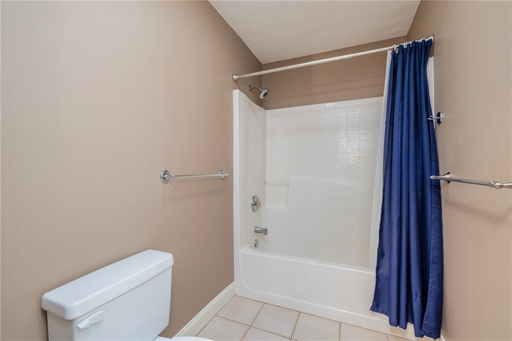 394 South Alexander Creek Road Newnan, GA 30263 - Photo 39 of 76 a bathroom with a shower and a toilet