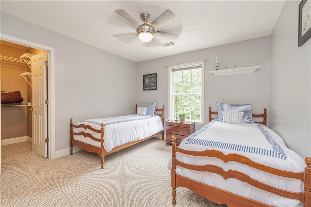 394 South Alexander Creek Road Newnan, GA 30263 - Photo 40 of 76 a bedroom with a bed and a chandelier