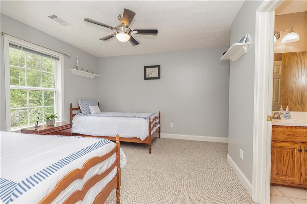 394 South Alexander Creek Road Newnan, GA 30263 - Photo 41 of 76 a bedroom with a bed and a window