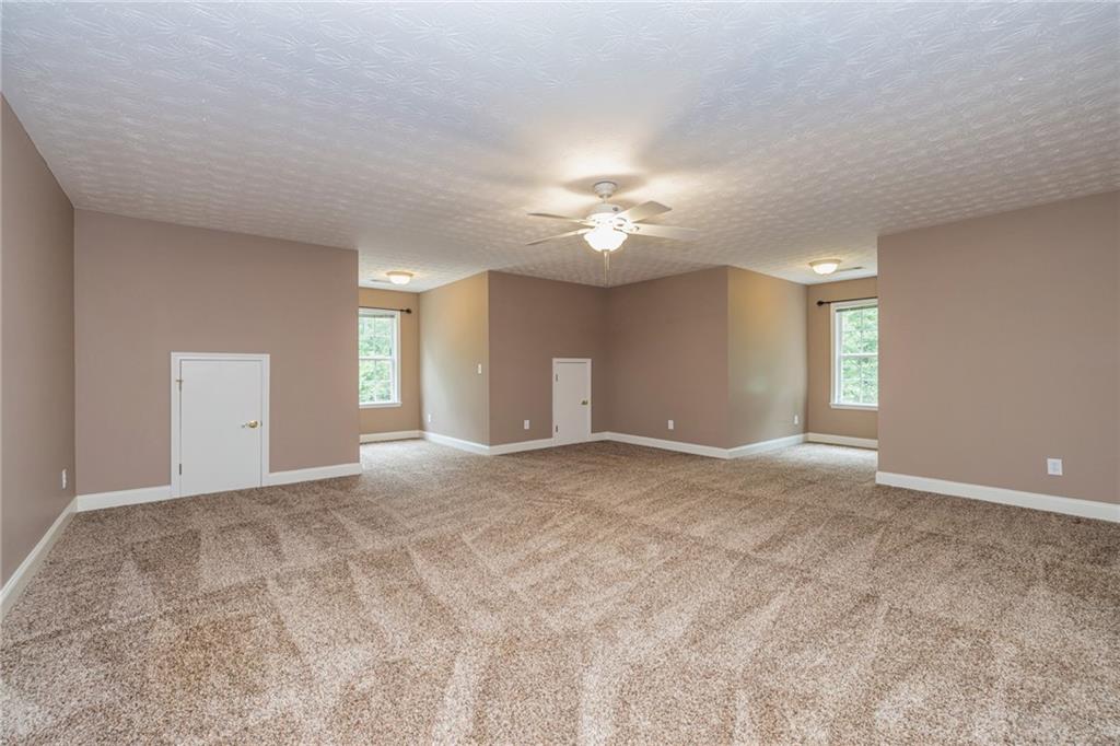 394 South Alexander Creek Road Newnan, GA 30263 - Photo 42 of 76 a view of an empty room with a chandelier fan