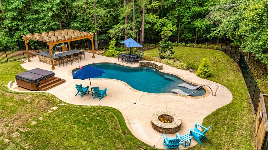 394 South Alexander Creek Road Newnan, GA 30263 - Photo 66 of 76 a view of swimming pool with a table and chairs
