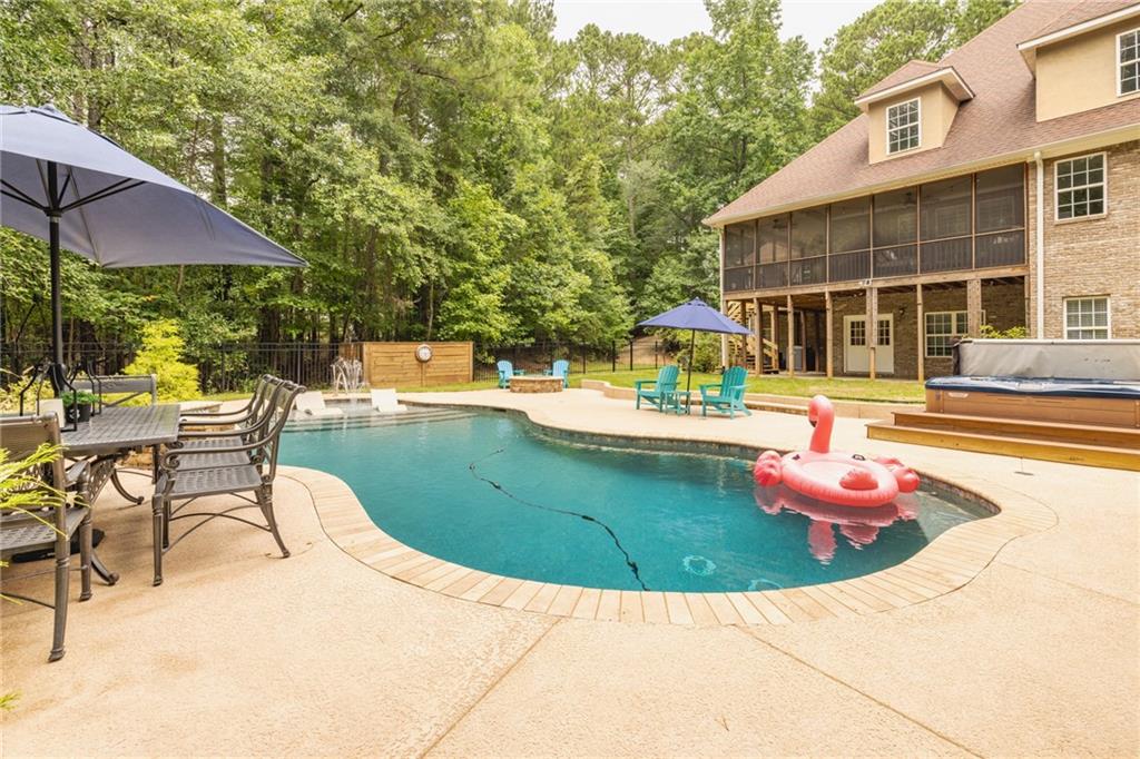 394 South Alexander Creek Road Newnan, GA 30263 - Photo 7 of 76 a view of a swimming pool with a lounge chairs