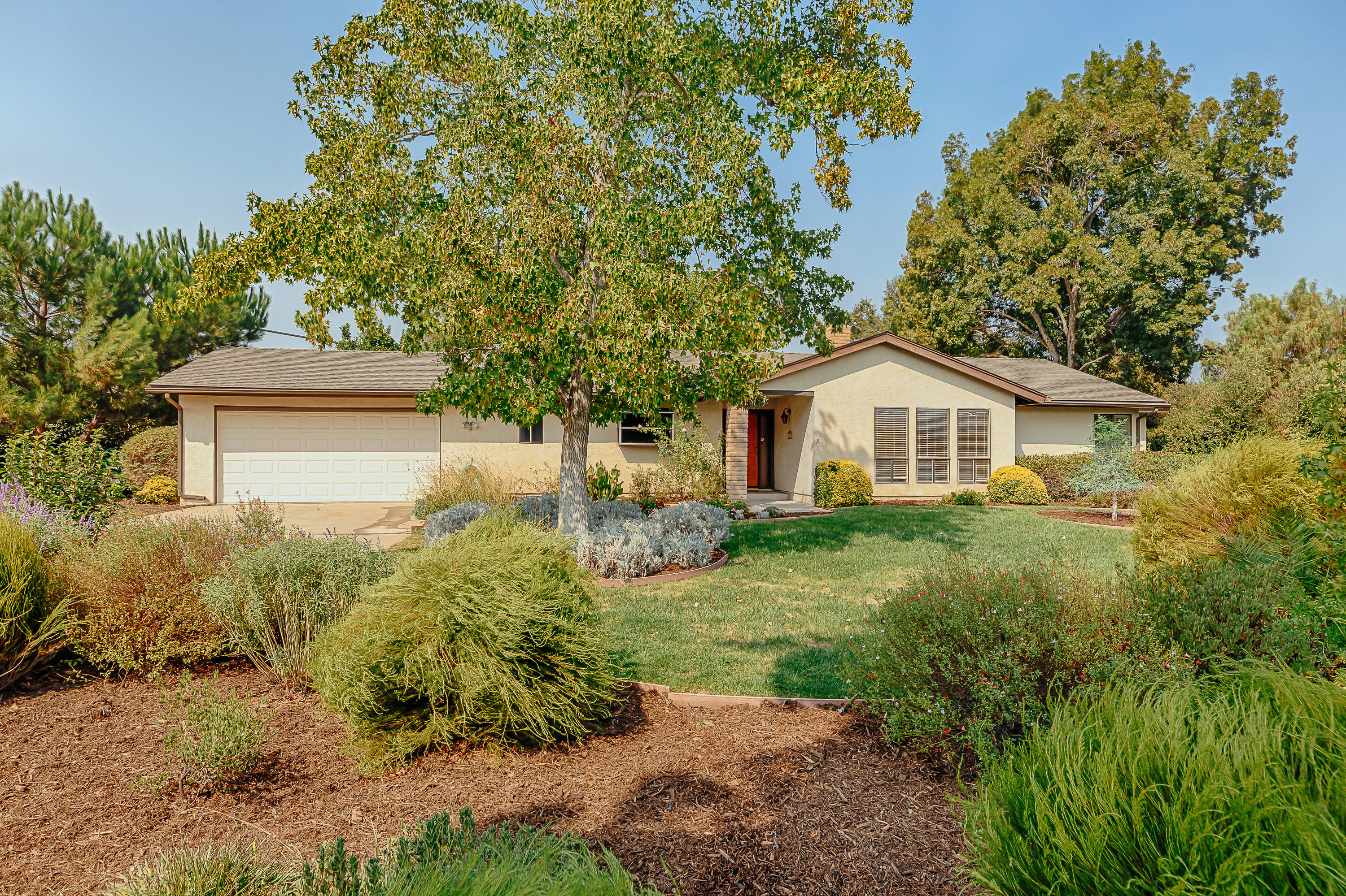 a yellow and red house with a garden