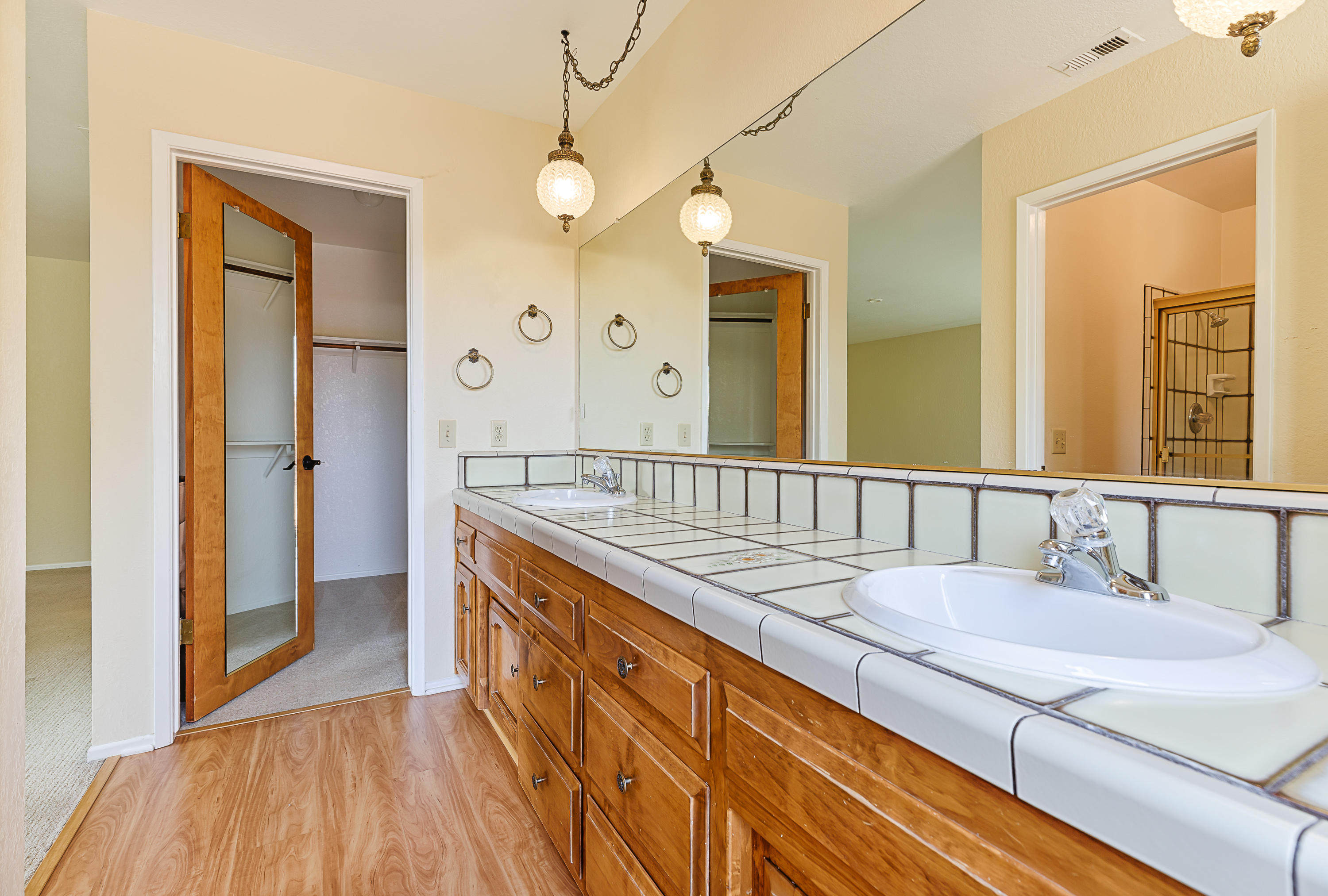 1837 Viborg Road Solvang, CA 93463 - Photo 11 of 20 a bathroom with a granite countertop sink and a mirror